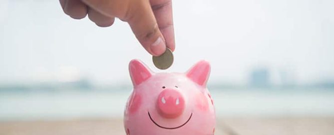 Homeowner saves coins by putting them in a piggy bank.