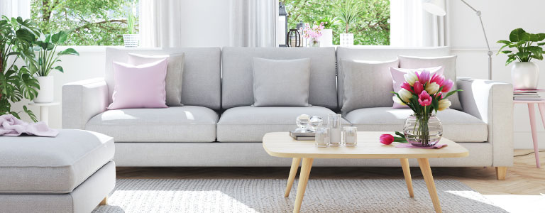Picture of clean living room with couch and flowers shows good indoor air quality.